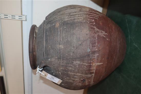 An Egyptian terracotta jar, with four carrying lug handles, Pre-Dynastic, H. 35cm, badly cracked